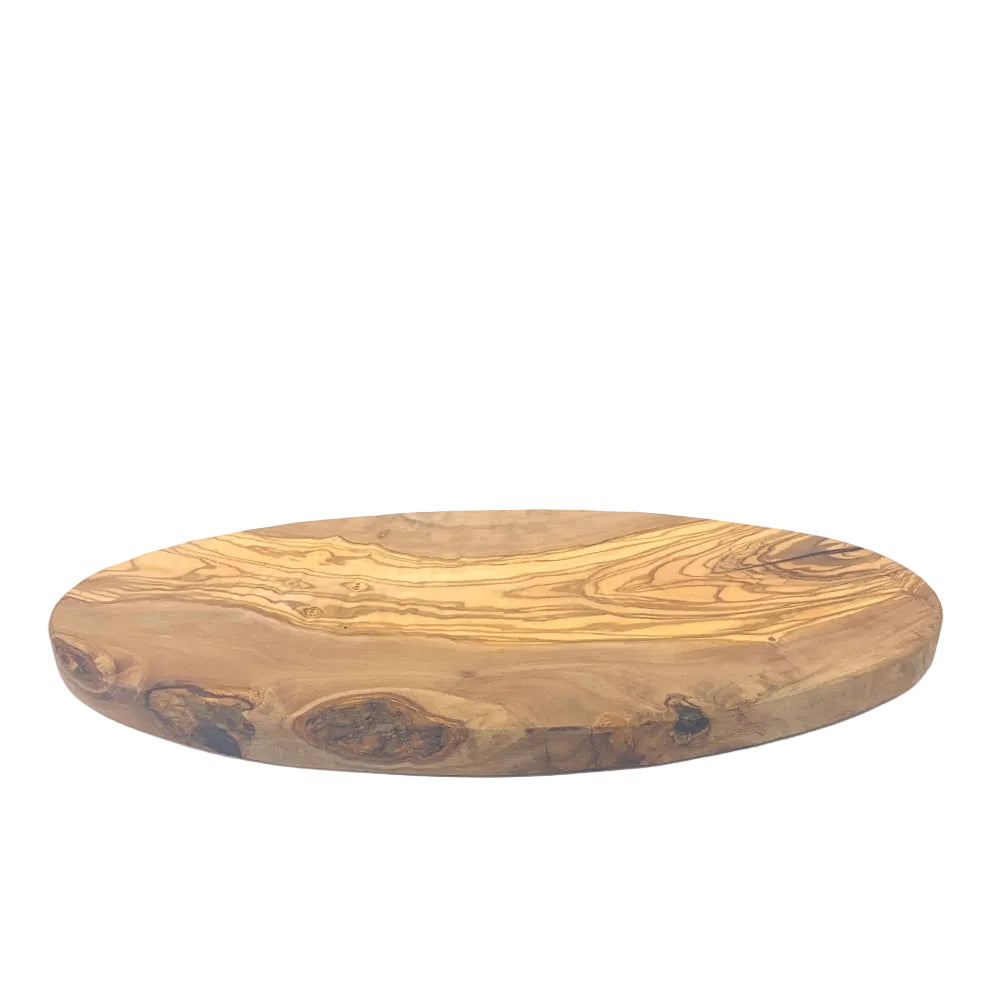An oval wooden serving board with a live edge and natural grain pattern, photographed on a white studio background.