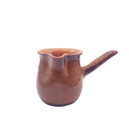 A small brown ceramic pourer with a flared rim and a short handle, shown on a plain light gray background.
