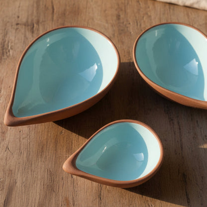 3 terracotta bowls with a blue glaze interior