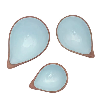 3 terracotta bowls with a blue glaze interior