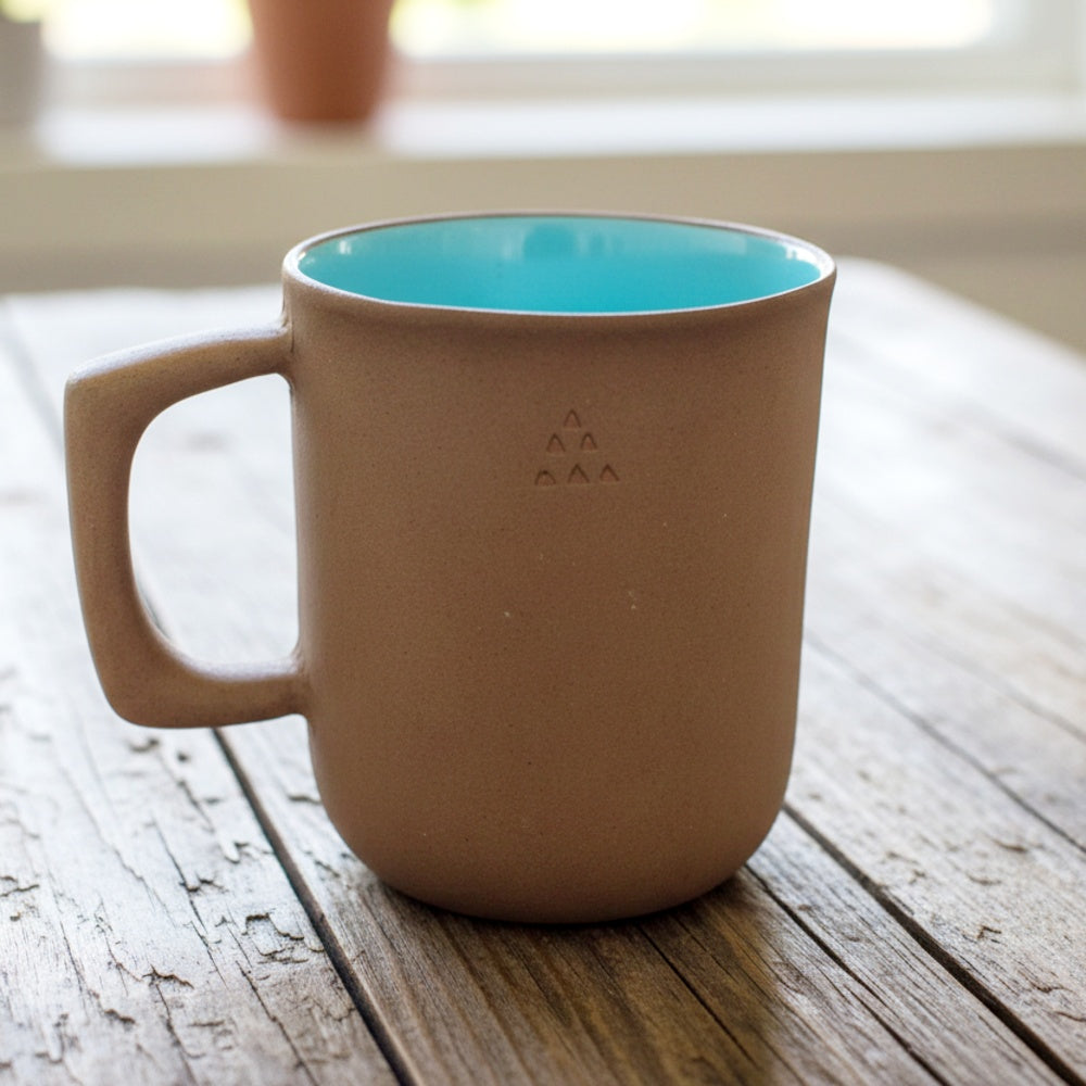 Terracotta handmade mug with a blue glaze interiors